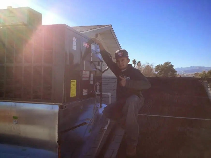 HVAC technician performing HVAC Inspection on a rooftop unit in Wake Village